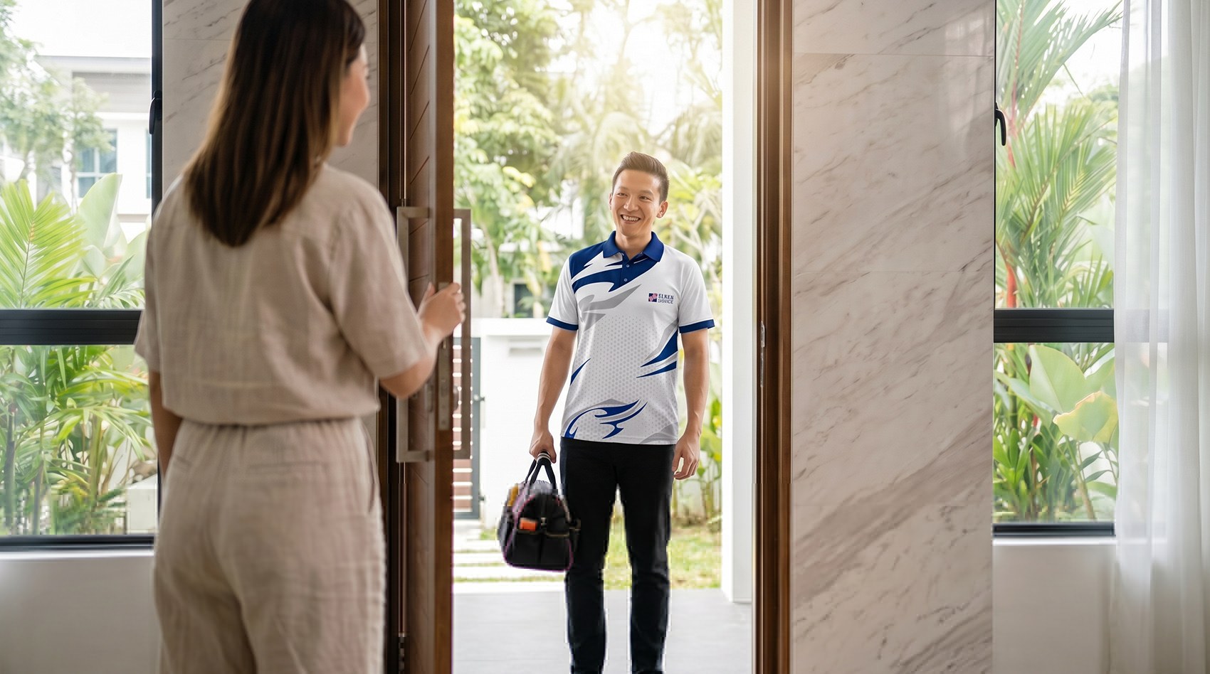 Elken Service technician greeting a homeowner at the door